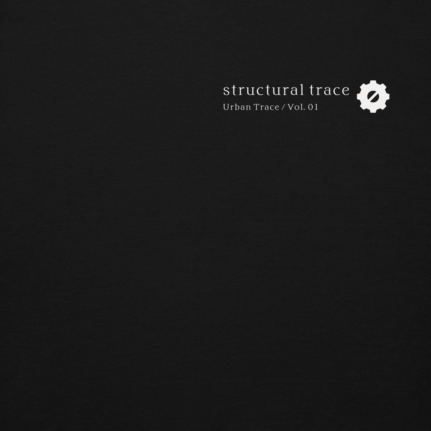 Minimalist gear symbol logo detail on black hoodie, Japanese industrial streetwear aesthetic.