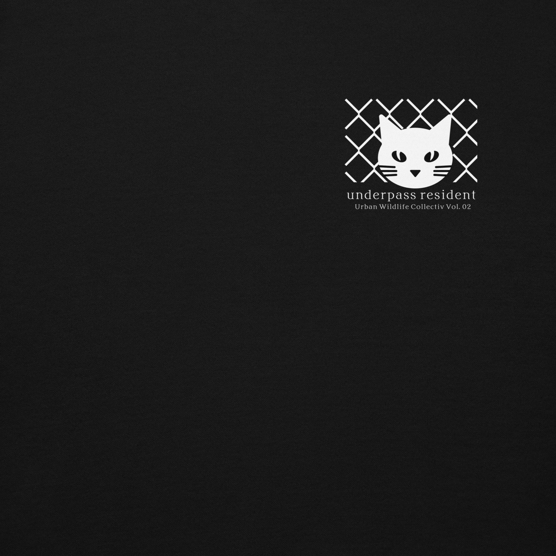 Minimalist feline symbol logo detail on black hoodie, Japanese urban streetwear aesthetic.