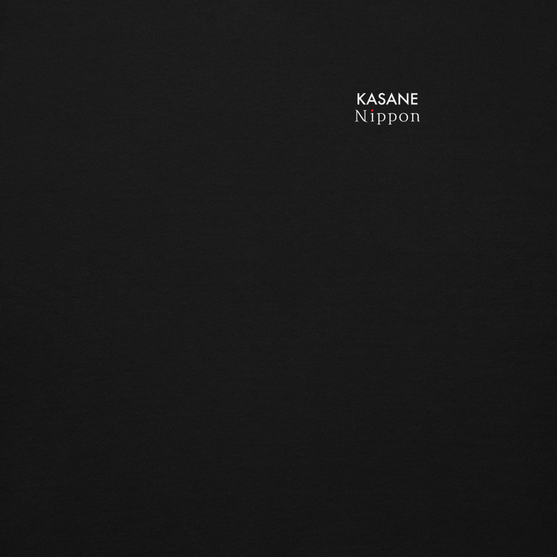Close-up of the minimal KASANE NIPPON brand logo on the black hoodie chest