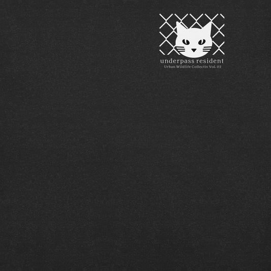 Minimalist feline symbol logo detail on black t-shirt, Japanese urban streetwear aesthetic.